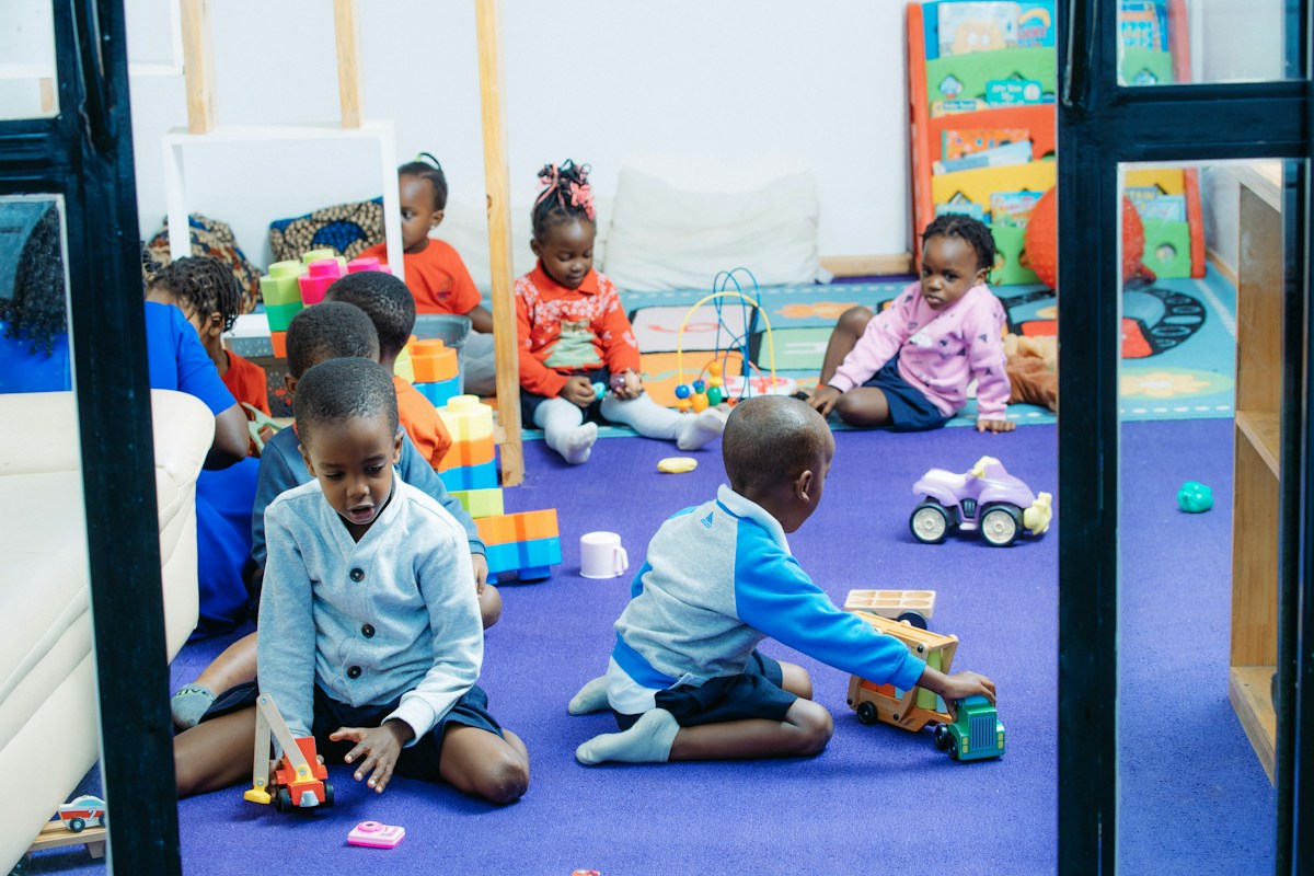 Children exploring colorful toys together in a bright playroom